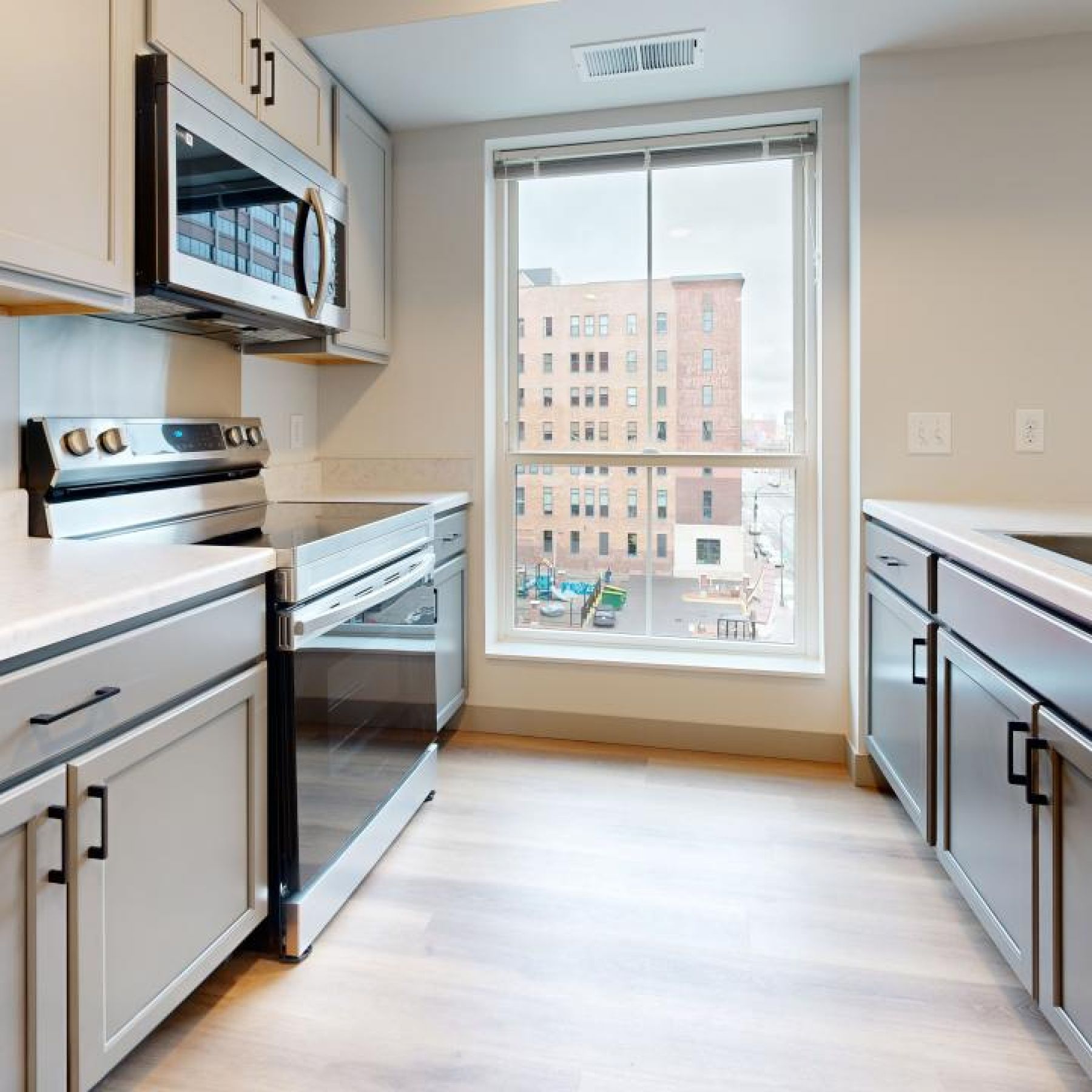 Ladder 260 apartment kitchen with large windows and custom cabinets