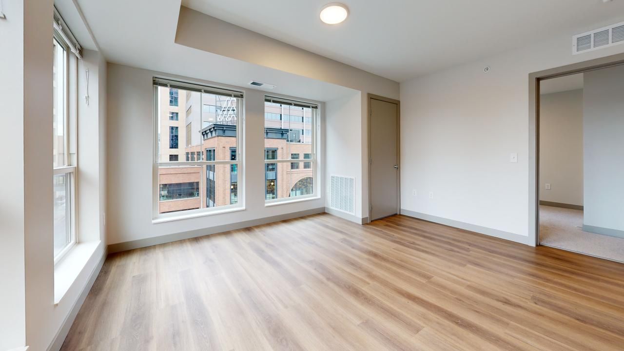 Ladder 260 apartment interior with wood-like floors, high ceilings and large windows