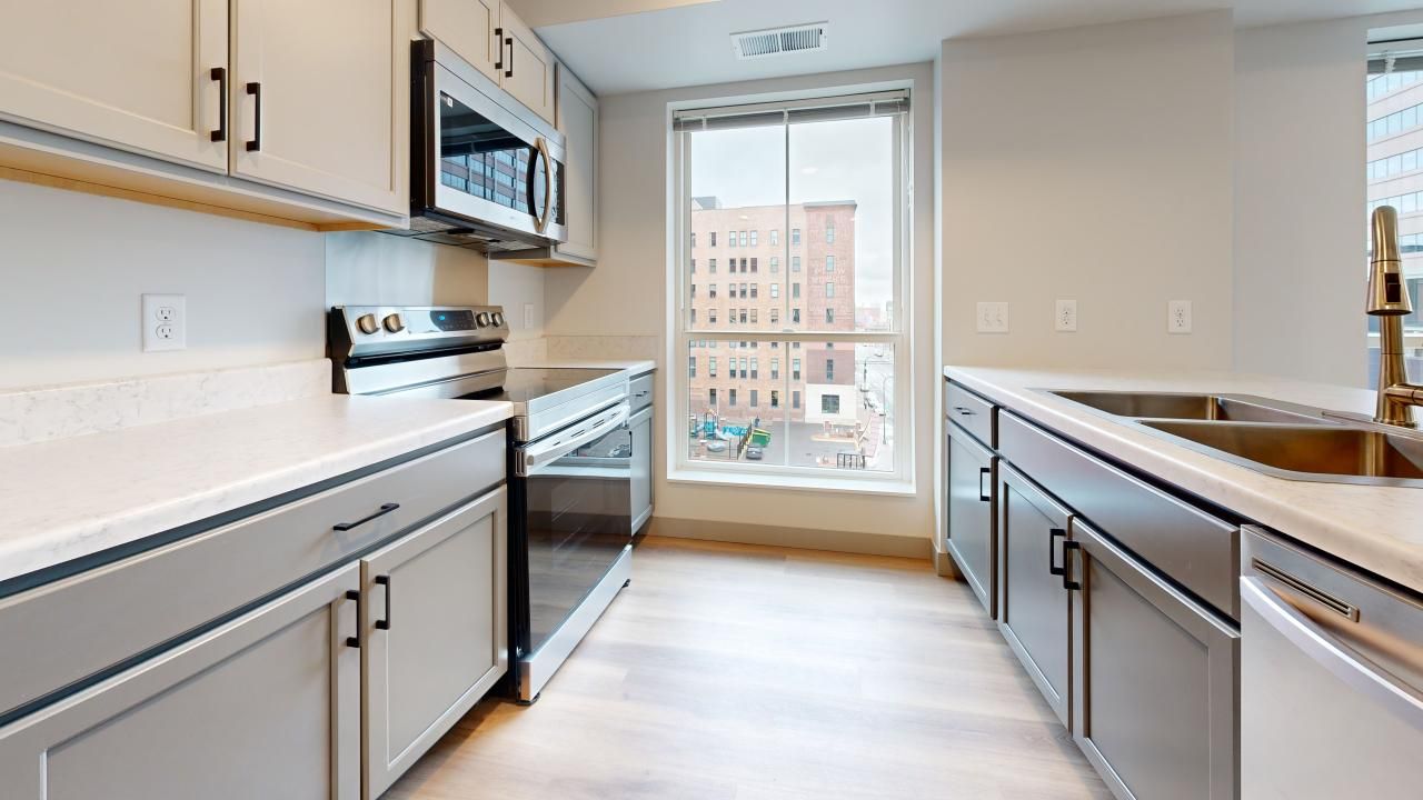 Ladder 260 apartment kitchen with large windows and custom cabinets