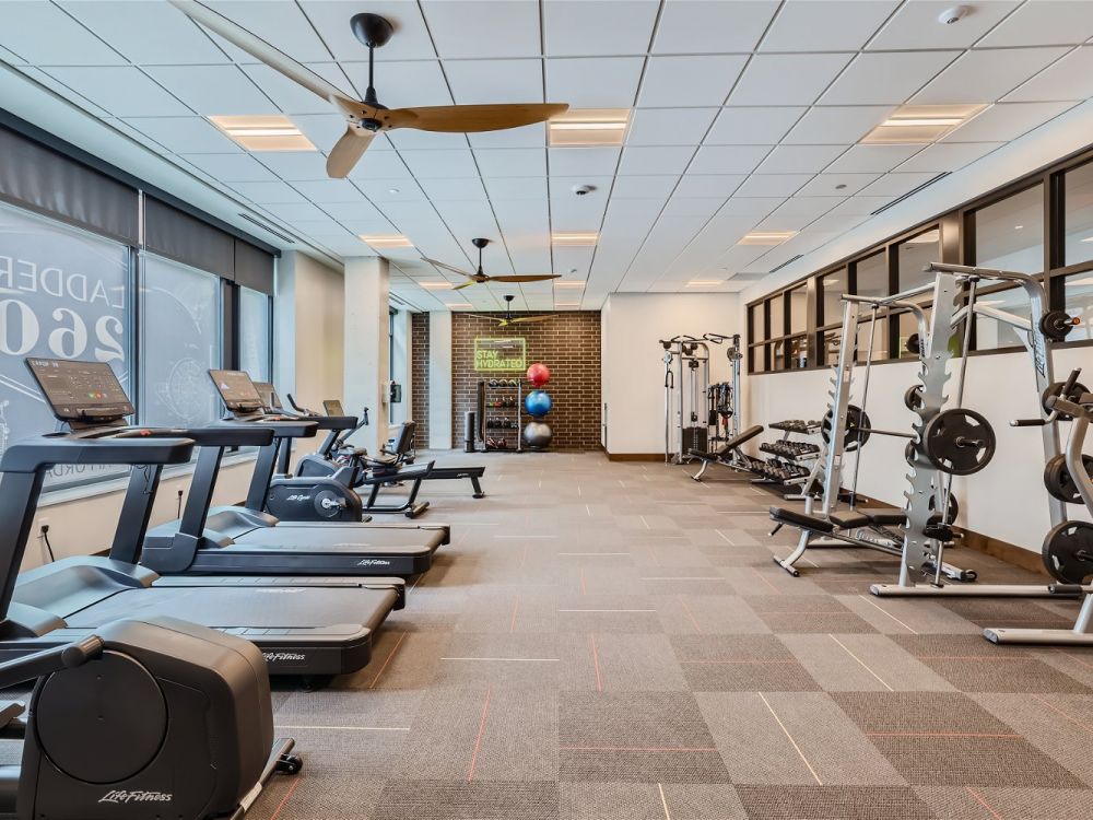 The well-equipped fitness center at Ladder 260 featuring treadmills, weight machines, and a variety of exercise equipment.